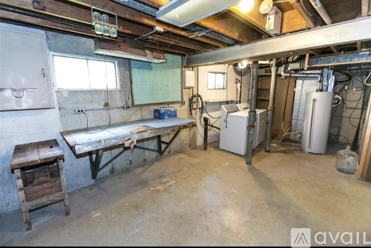 A room with a table, a cabinet, and a window.