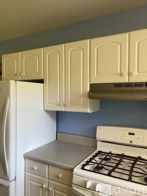 A kitchen with a white refrigerator and a white gas stove.