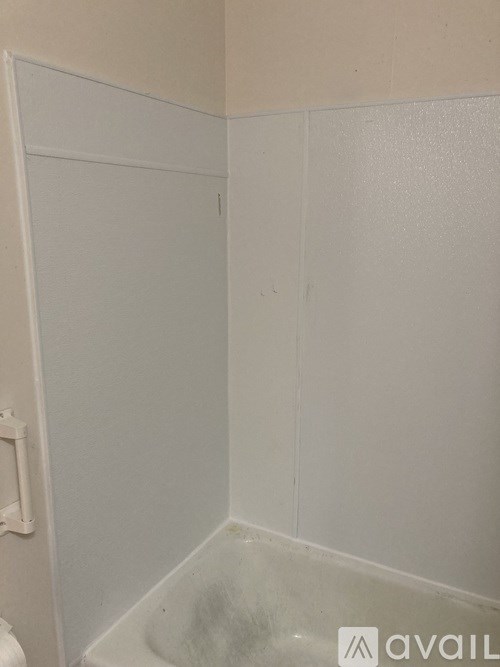 A white bathroom with a toilet and a white door.