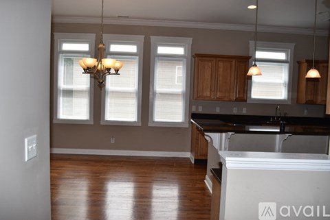 A kitchen with wooden cabinets and a white island.