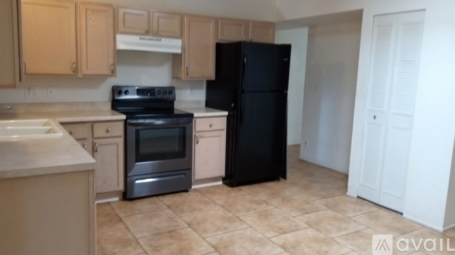 A kitchen with a black fridge and stove.
