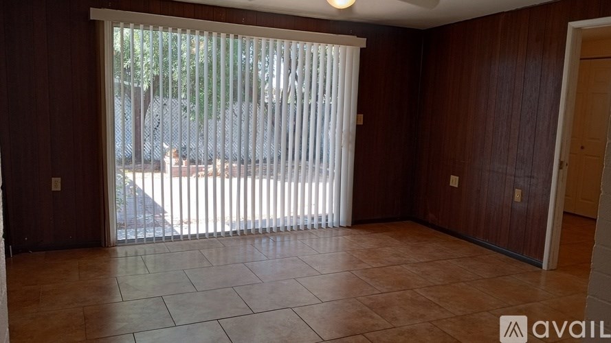 A room with a sliding door and a tiled floor.