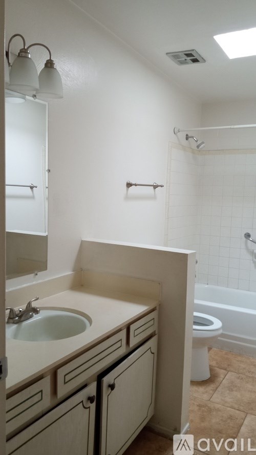 A bathroom with a sink, toilet, and bathtub.