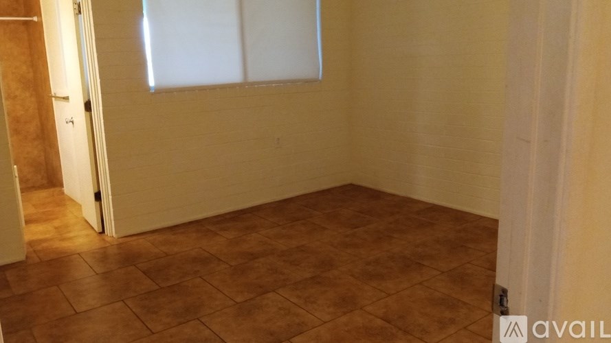 A room with a tiled floor and a window.