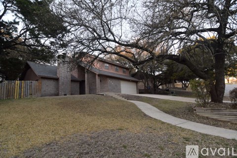 A house with a tree in front of it.