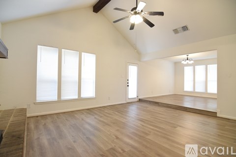 A room with a ceiling fan and a window.
