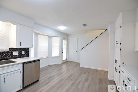 A room with a fireplace and a ceiling fan.