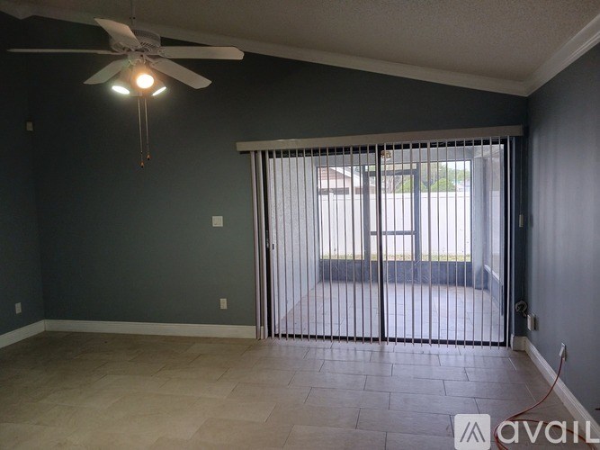 A room with a sliding glass door leading to a balcony.