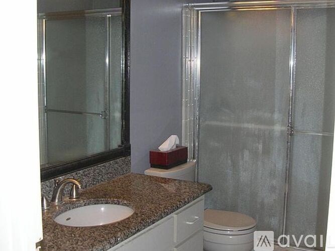 A bathroom with a sink, toilet, and shower.