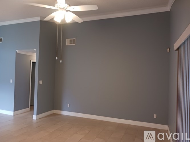 A room with a ceiling fan and light fixture.
