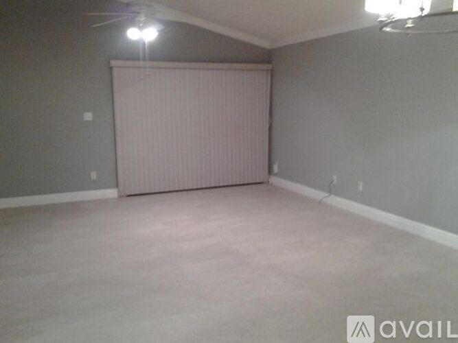 A room with a sliding door and a ceiling fan.