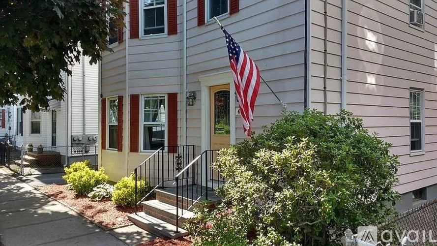 A house with a flag on the front porch.