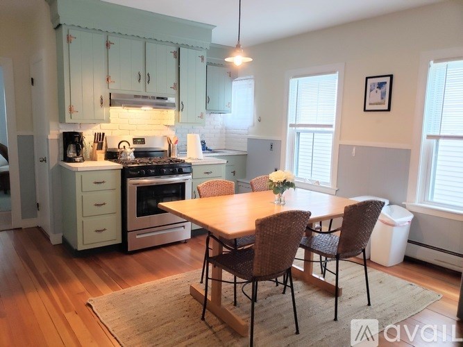 A kitchen with a table and chairs in the middle of the room.