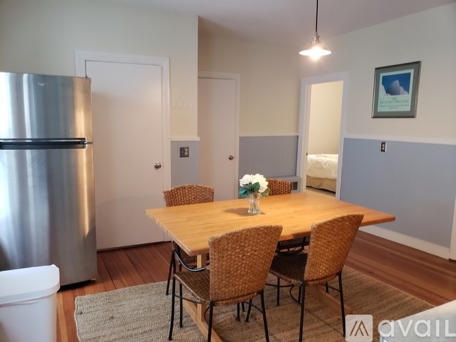 A kitchen with a table and chairs.