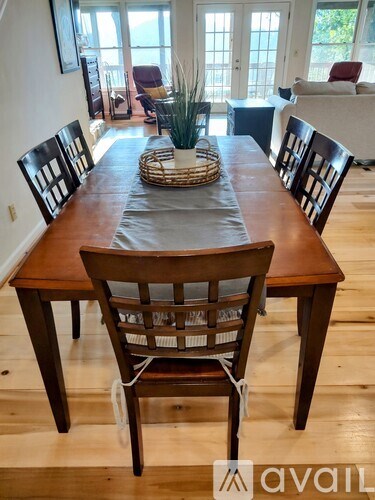 A wooden dining table with chairs and a basket on top.