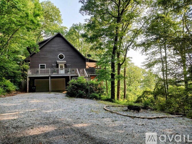 A house with a gravel driveway in front of it.