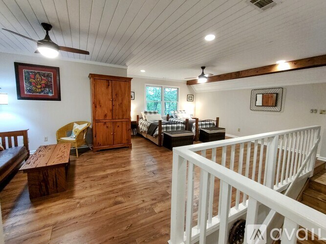 A living room with wooden floors and furniture.