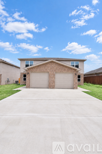 A house with a white garage door in front.