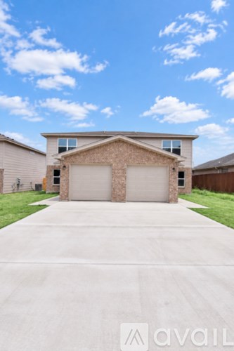 A house with a white garage door in front.