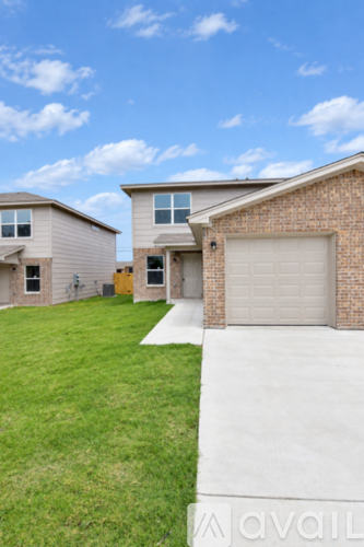 A house with a grey roof and a garage door.