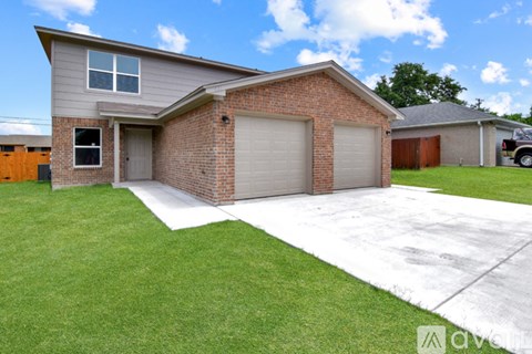 A house with a grey roof and a garage door.
