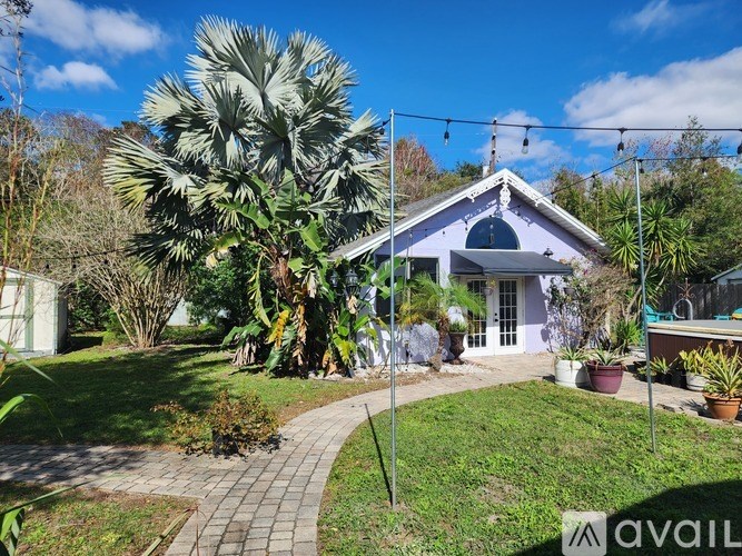 A house with a purple roof and a garden in front.
