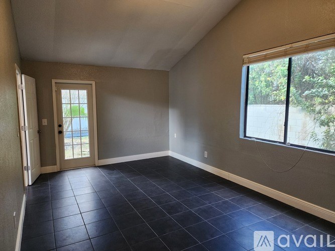 A room with a tiled floor and a large window.