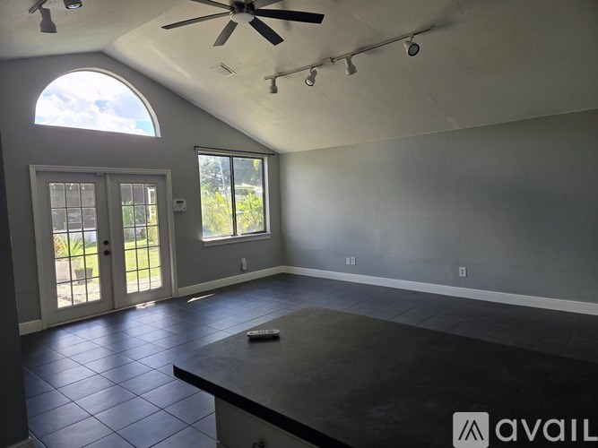 A hallway with a white door and a black tiled floor.