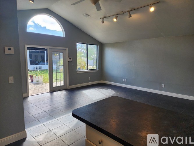 A spacious room with a large island in the middle.