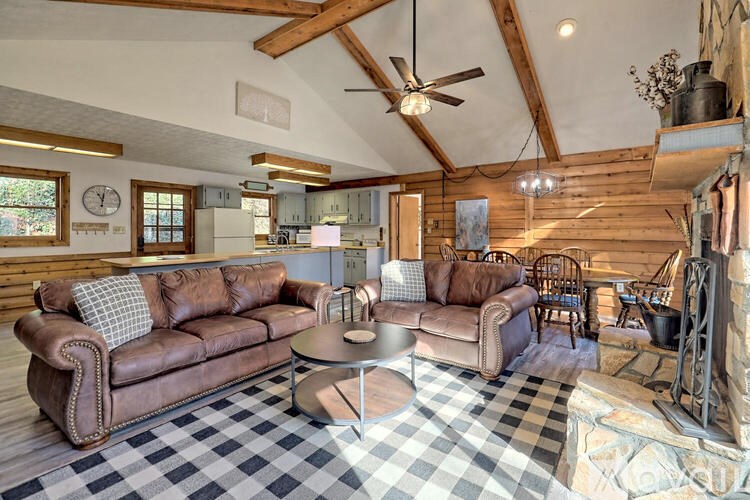 A living room with a checkered floor and a fireplace.