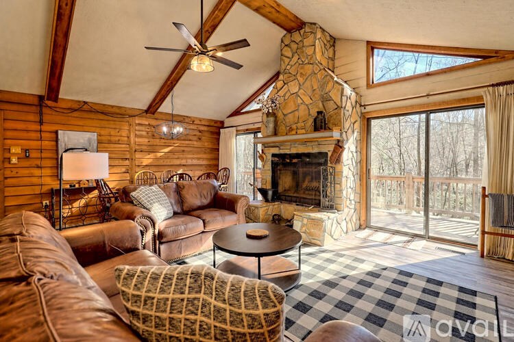 A living room with a fireplace and a checkered rug.