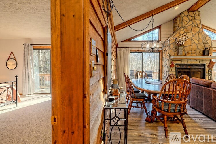 A cozy living room with a fireplace and wooden furniture.