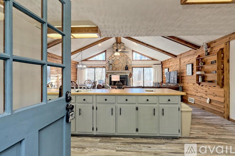 A kitchen with a wooden ceiling and cabinets.