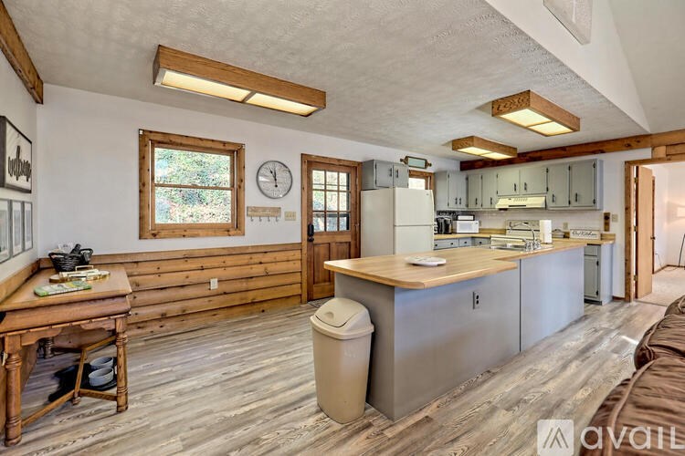 A kitchen with wooden floors and a large island in the middle.