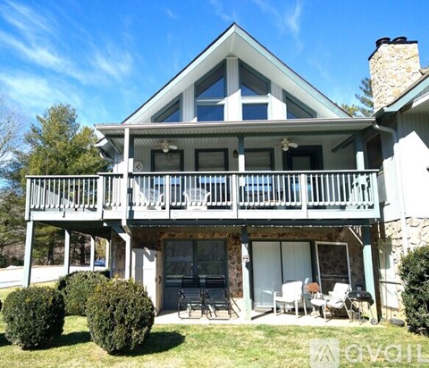A house with a balcony and a fireplace.