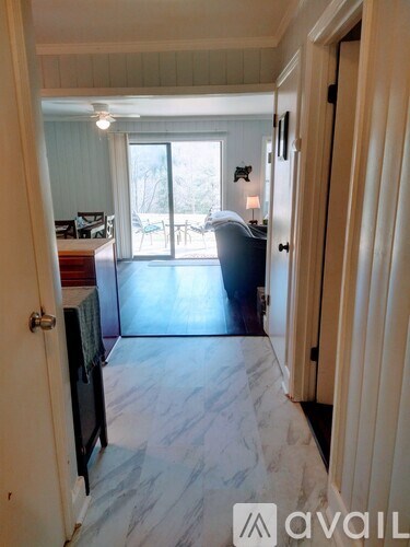 A room with a sliding glass door leading to a balcony.