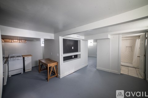 A kitchen area with a dining table and a refrigerator.