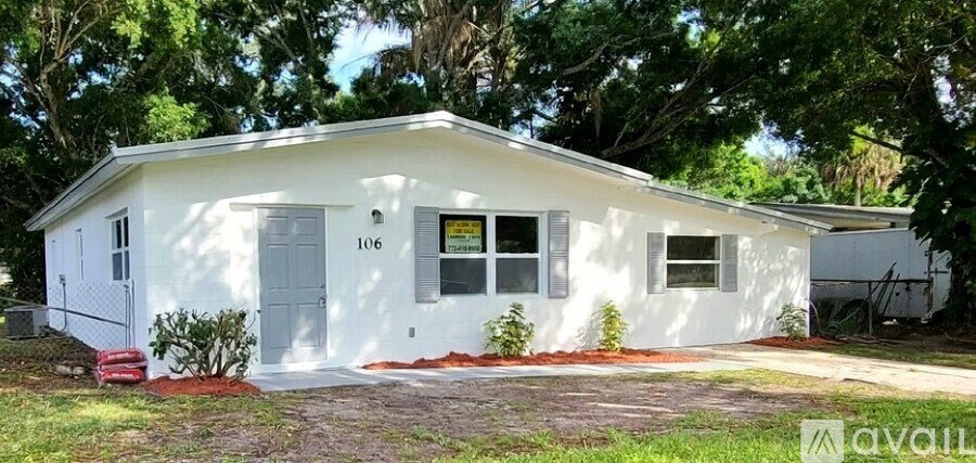 A small white house with the number 106 on the front door.