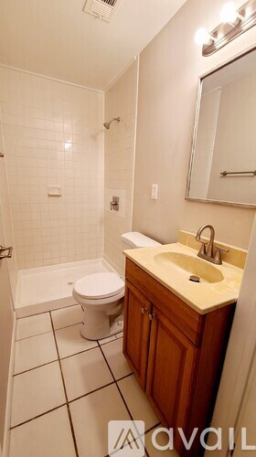 A white toilet sits next to a sink in a bathroom.