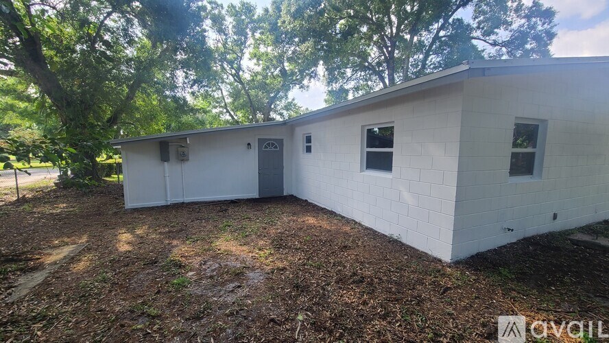 A white building with a sign that says "AVAILABLE" in front of it.