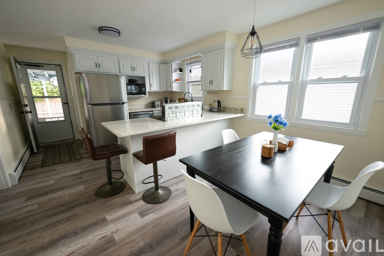 A kitchen with a table and chairs in the middle of the room.