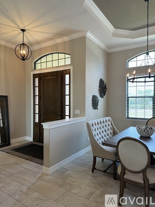 A dining room with a wooden table and chairs.