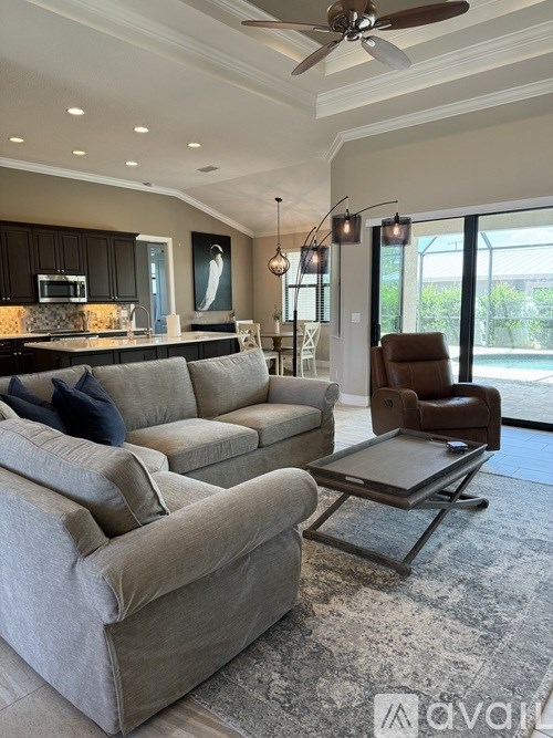 A living room with a grey couch and a brown chair.