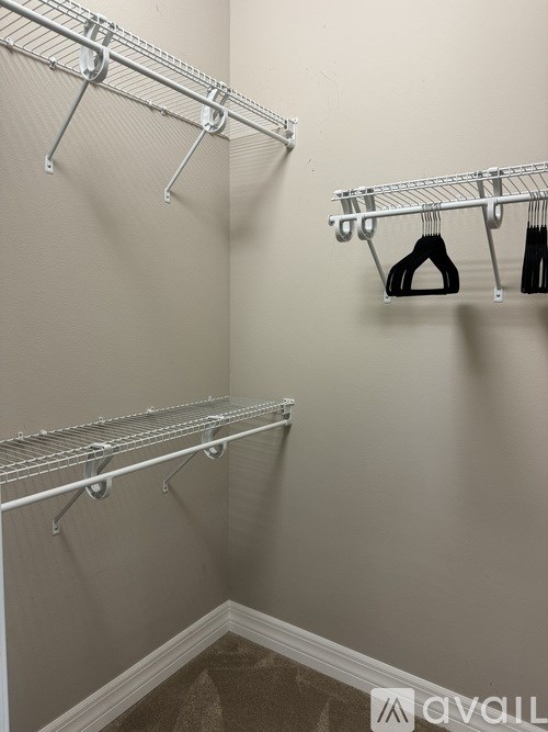 A white metal rack with clothes hangers.