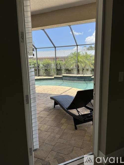 A patio with a pool table and a chair.