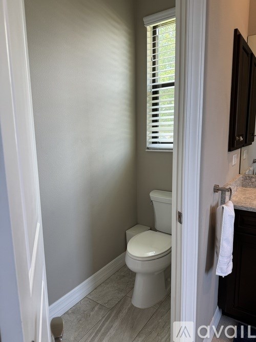 A white toilet in a bathroom with a white door.