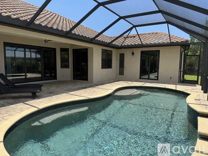 A pool in a covered patio area.