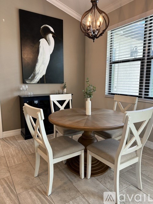 A dining room with a wooden table and chairs.