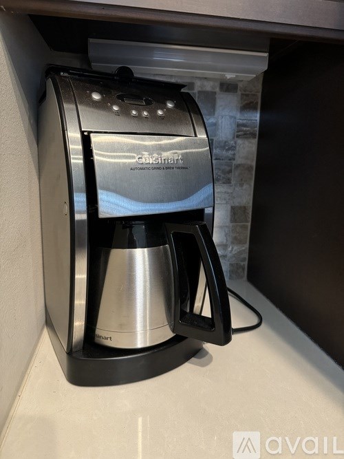 A Cuisinart coffee maker is on a counter.