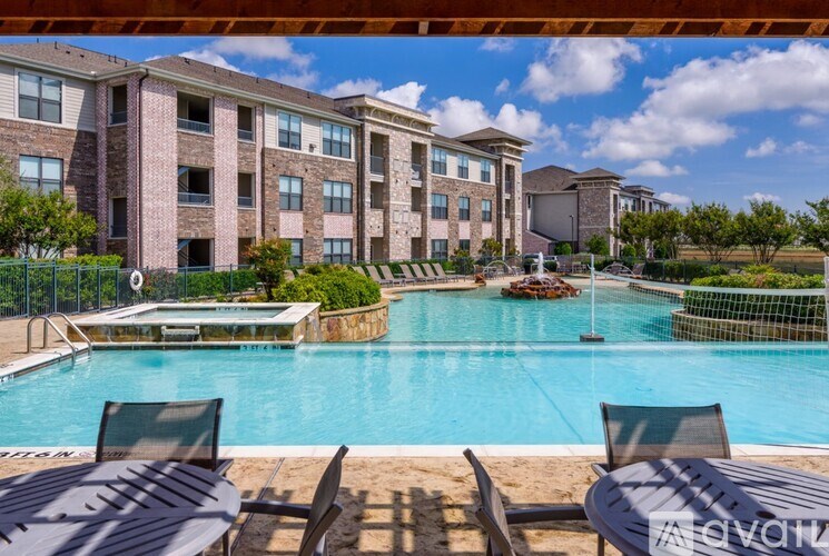 A pool area with chairs and a building in the background.